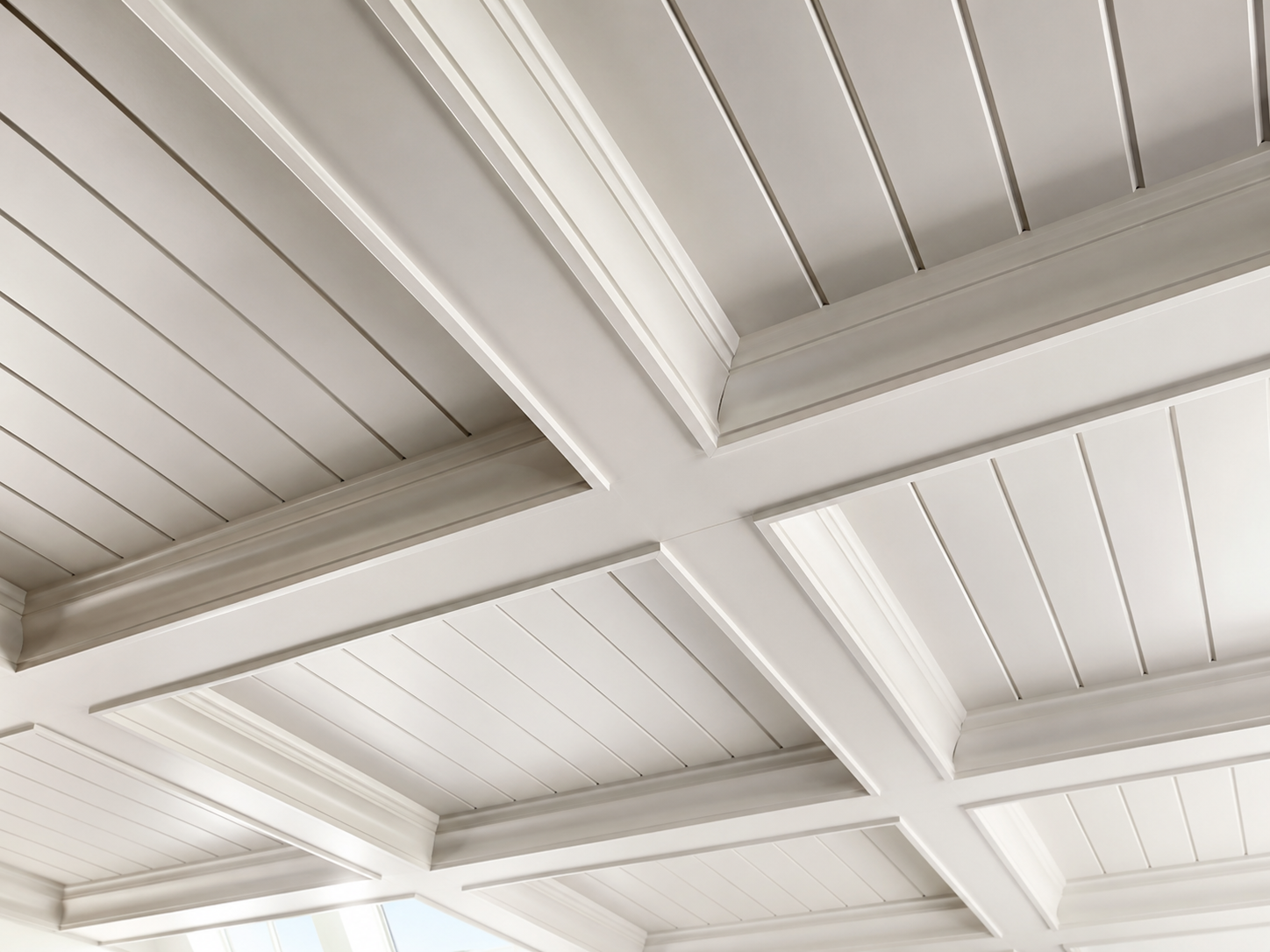 White coffered ceiling with tongue-and-groove panels and crown molding